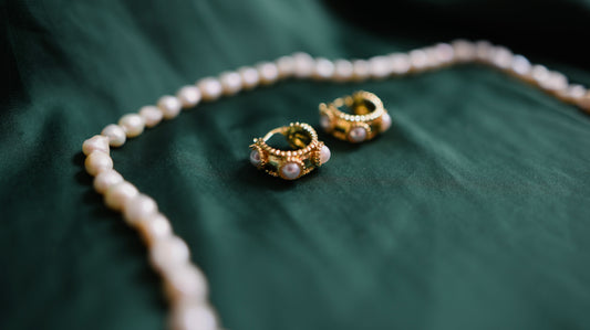 Goldene Ohrringe mit Perlendetail