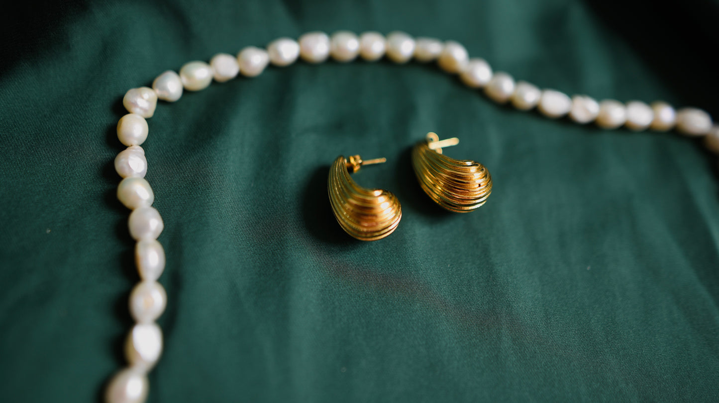 Gold earrings with a textured surface 