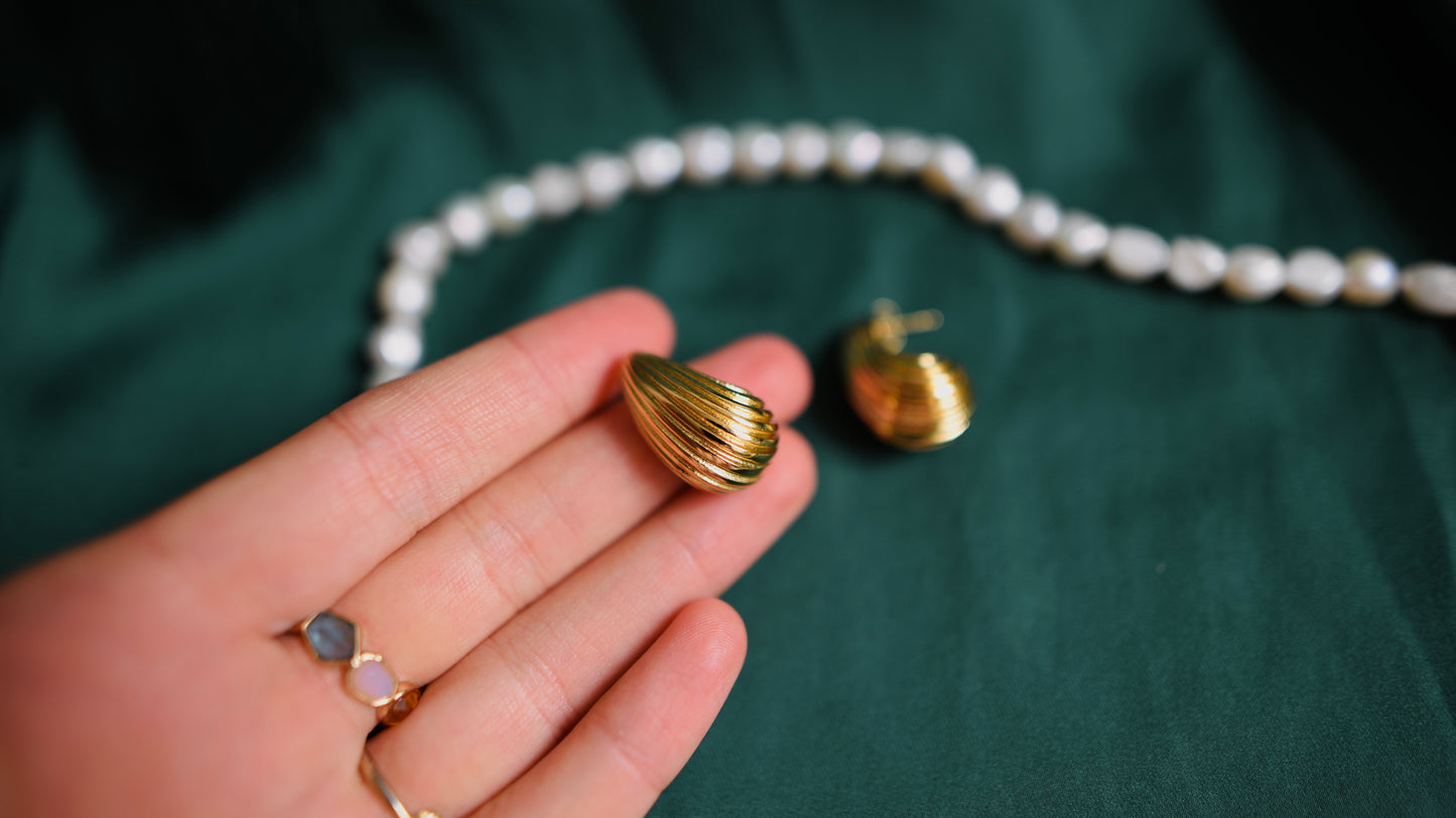 Gold earrings with a textured surface 