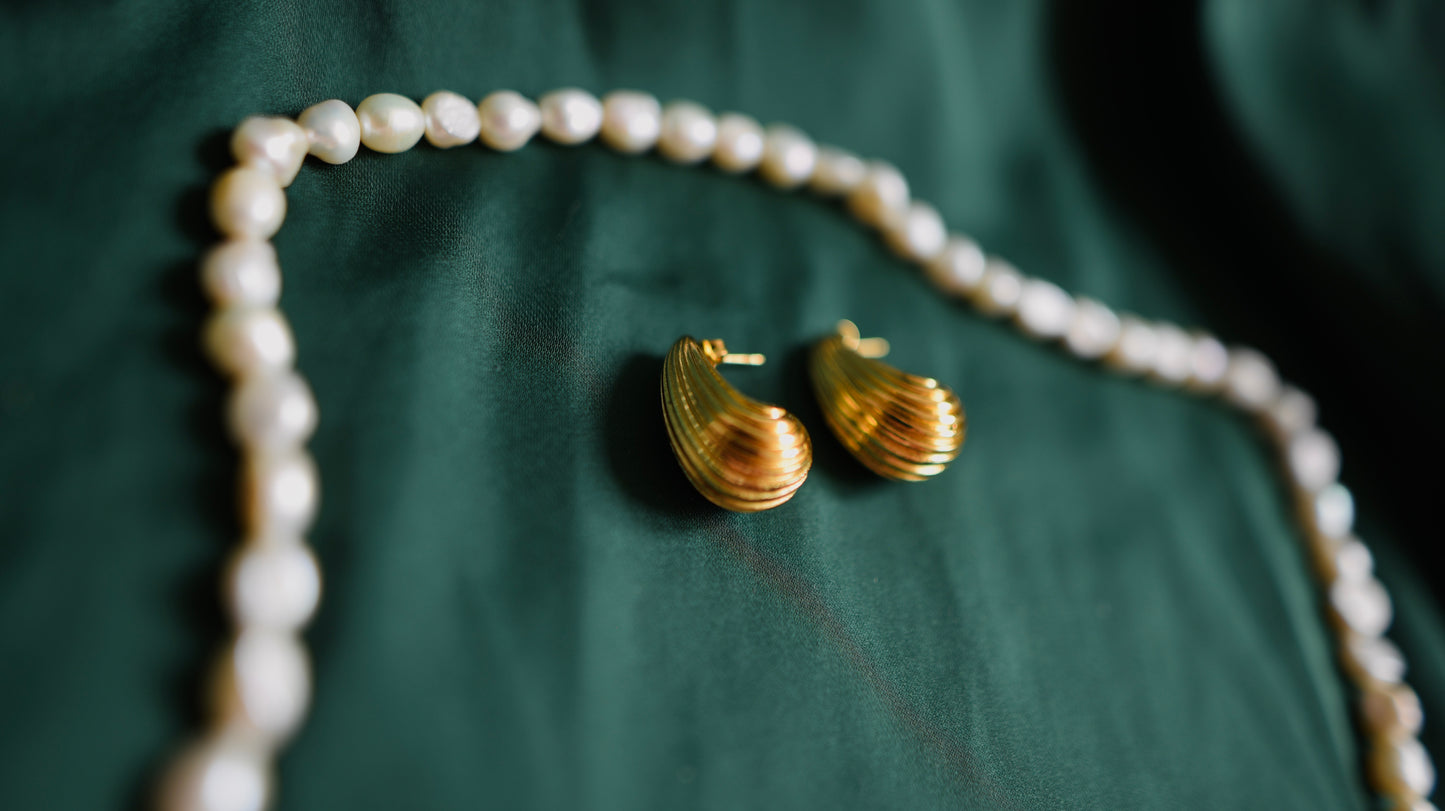 Gold earrings with a textured surface 