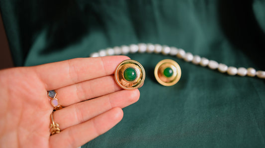 Gold earrings with a green stone 