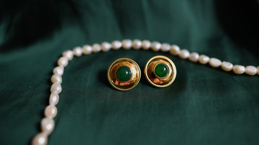 Gold earrings with a green stone 
